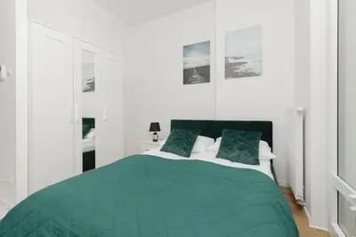 Łóżko lub łóżka w pokoju w obiekcie Business Apartments Kasprzaka by Noclegi Renters