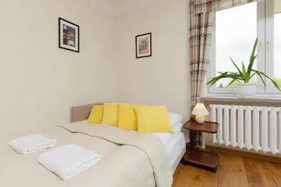 Łóżko lub łóżka w pokoju w obiekcie Metro Racławicka Cozy Studio Apartment by Noclegi Renters