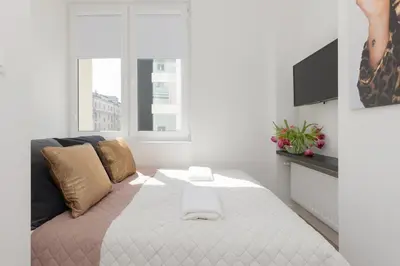 Łóżko lub łóżka w pokoju w obiekcie Fashionable City Center Apartment by Noclegi Renters
