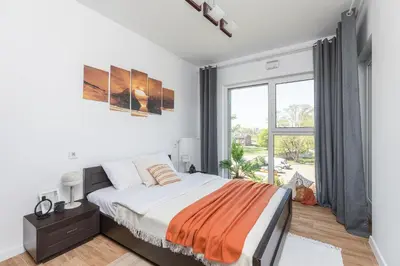 Łóżko lub łóżka w pokoju w obiekcie SuperApart Budowlana 5 - Nowoczesny Apartament
